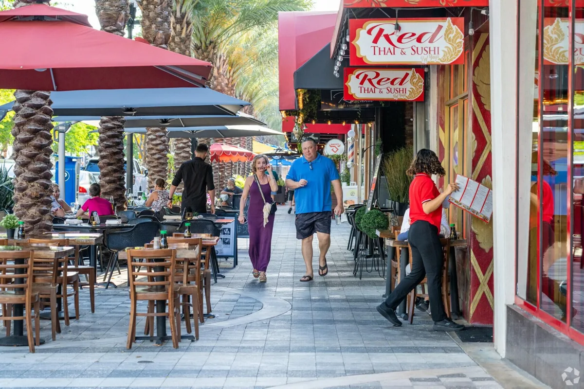 Red Thai and Sushi storefront beside a downtown sidewalk